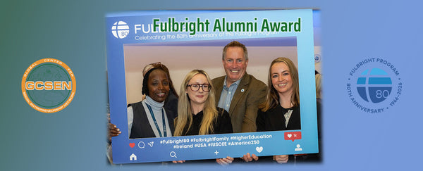 4 people holding up frame with text about fulbright. they are smiling. 3 are women and one is Mike Caslin.